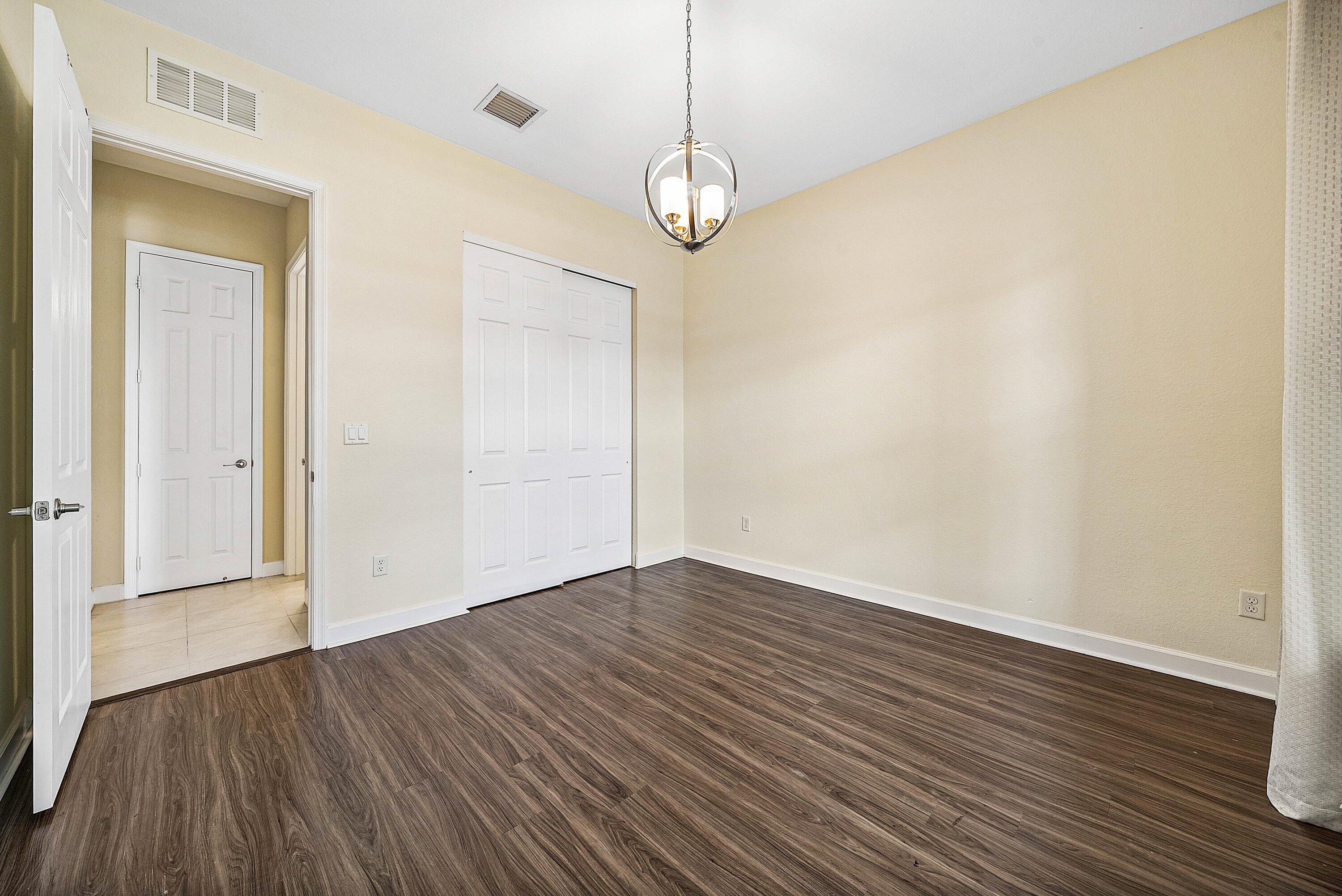 1031 Ember Ridge Run Loxahatchee, FL 33470 - Photo 36 of 52 a view of empty room with wooden floor and fan