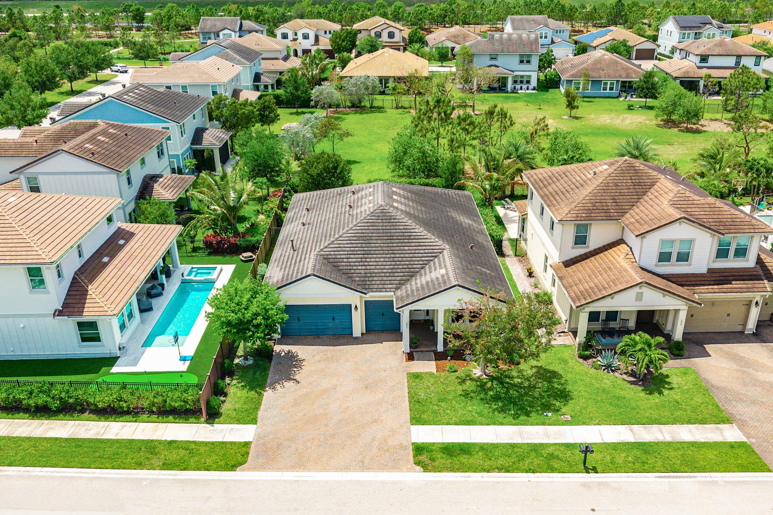 1031 Ember Ridge Run Loxahatchee, FL 33470 - Photo 41 of 52 a aerial view of multiple houses with yard