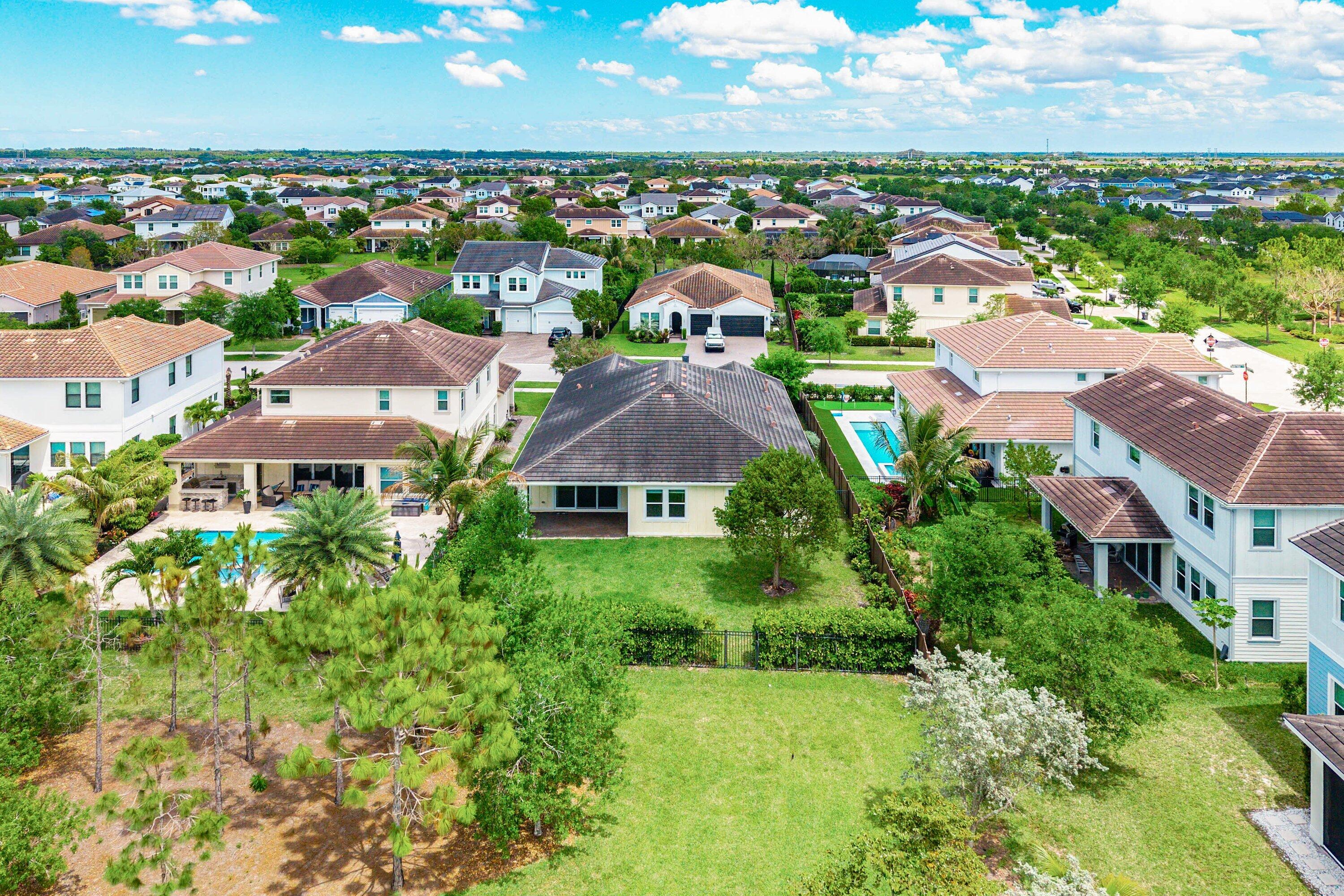 1031 Ember Ridge Run Loxahatchee, FL 33470 - Photo 45 of 52 an aerial view of residential houses with outdoor space and trees