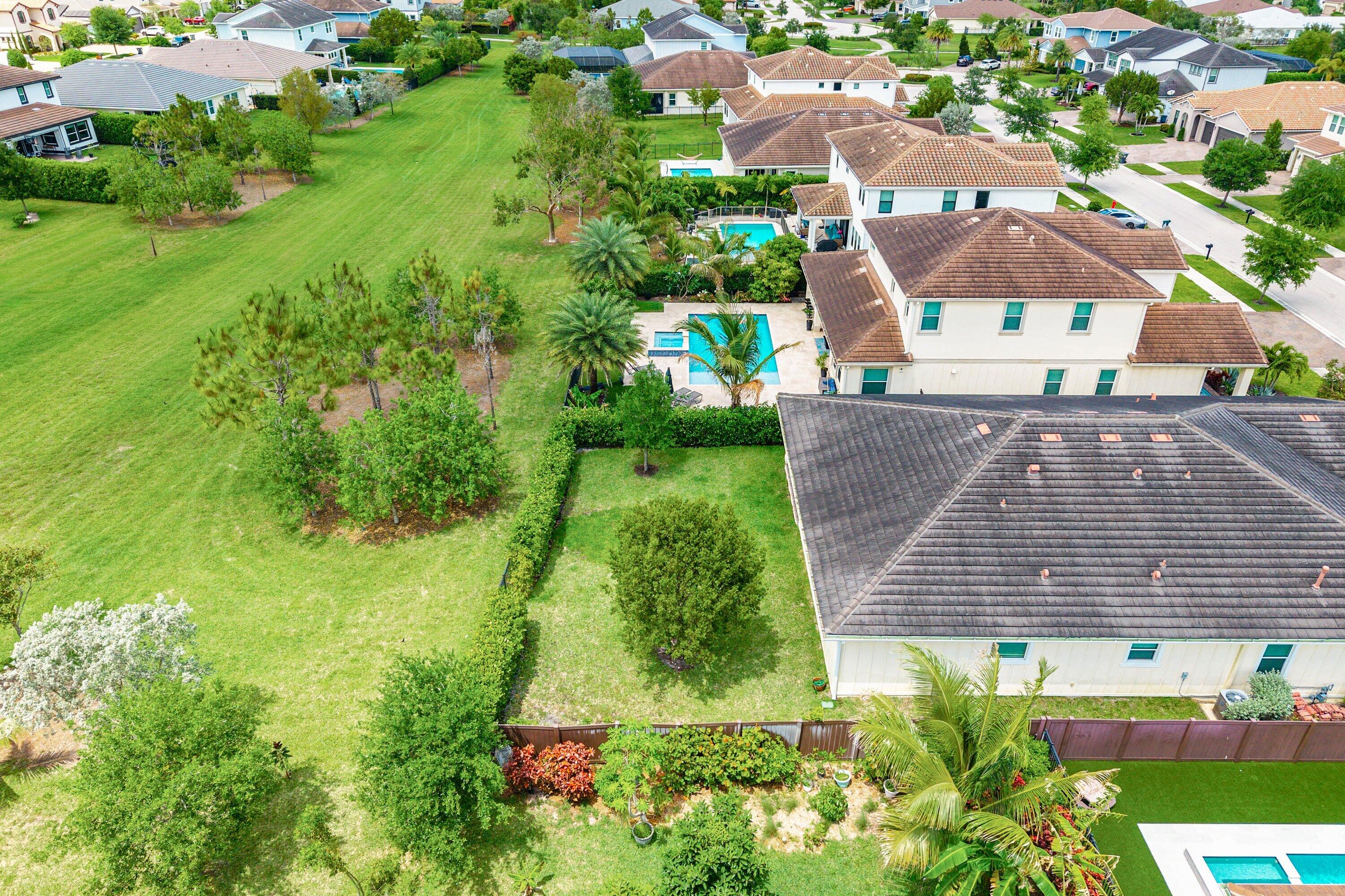 1031 Ember Ridge Run Loxahatchee, FL 33470 - Photo 46 of 52 an aerial view of residential houses with outdoor space and trees all around