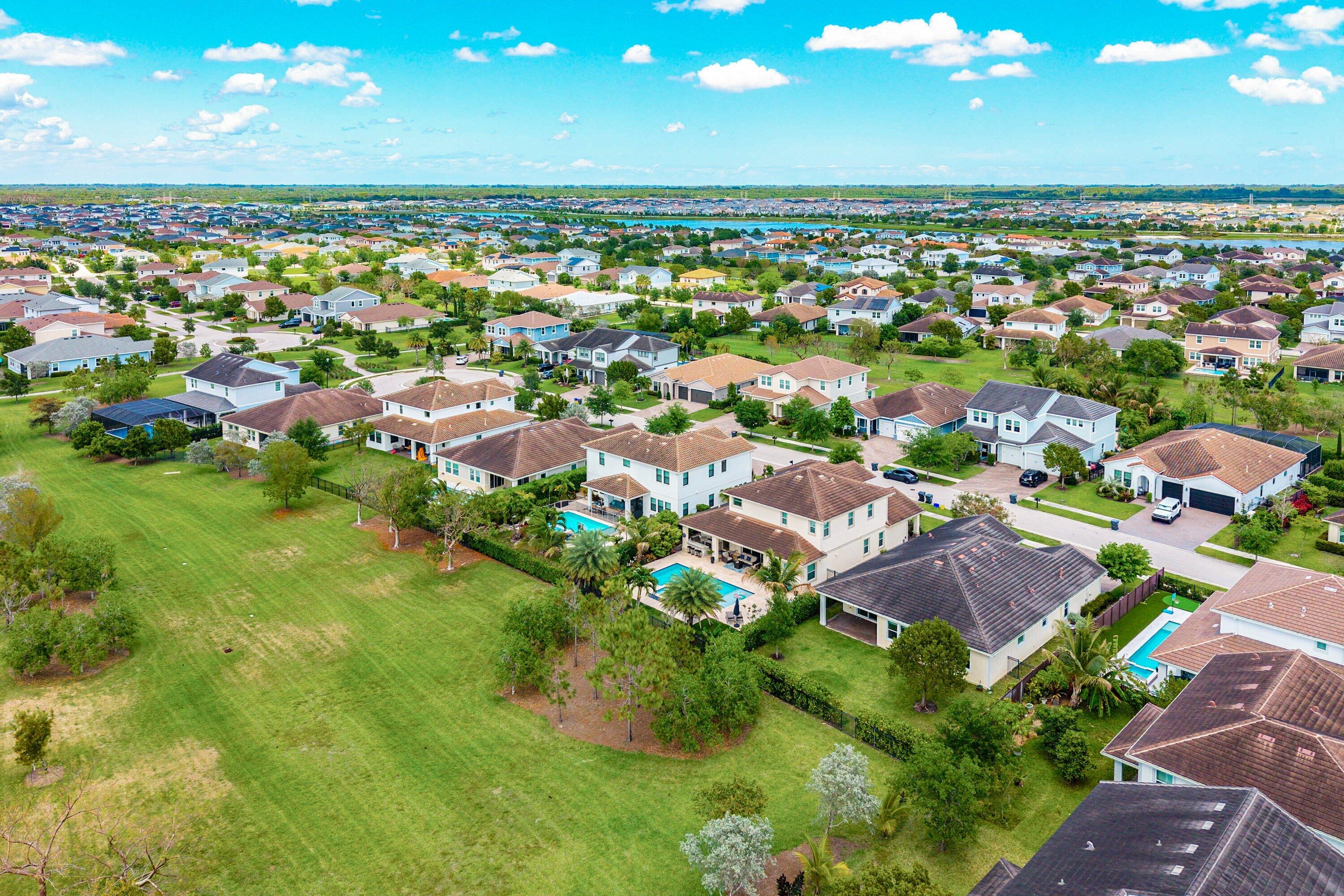 1031 Ember Ridge Run Loxahatchee, FL 33470 - Photo 48 of 52 an aerial view of residential houses with outdoor space and trees all around