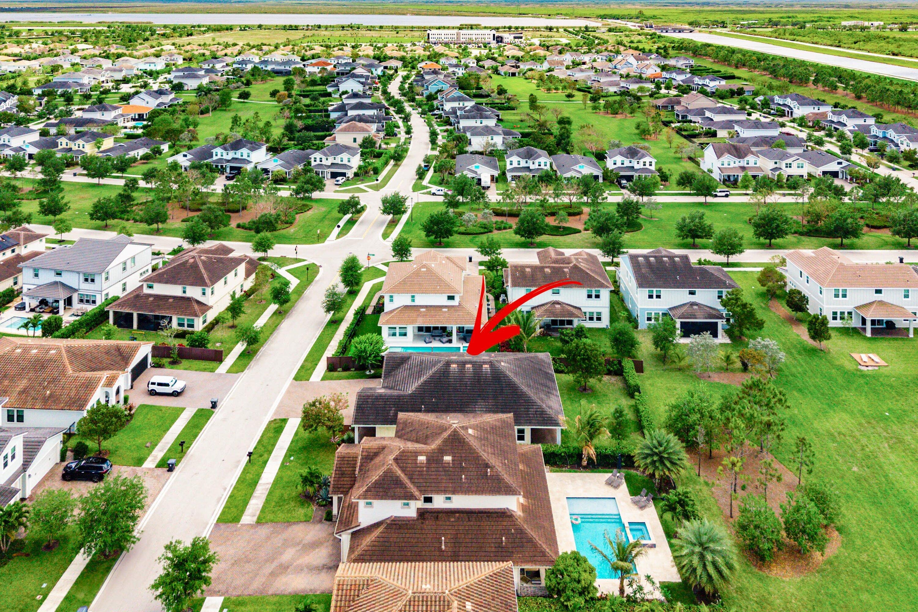 1031 Ember Ridge Run Loxahatchee, FL 33470 - Photo 49 of 52 an aerial view of residential houses with outdoor space and street view