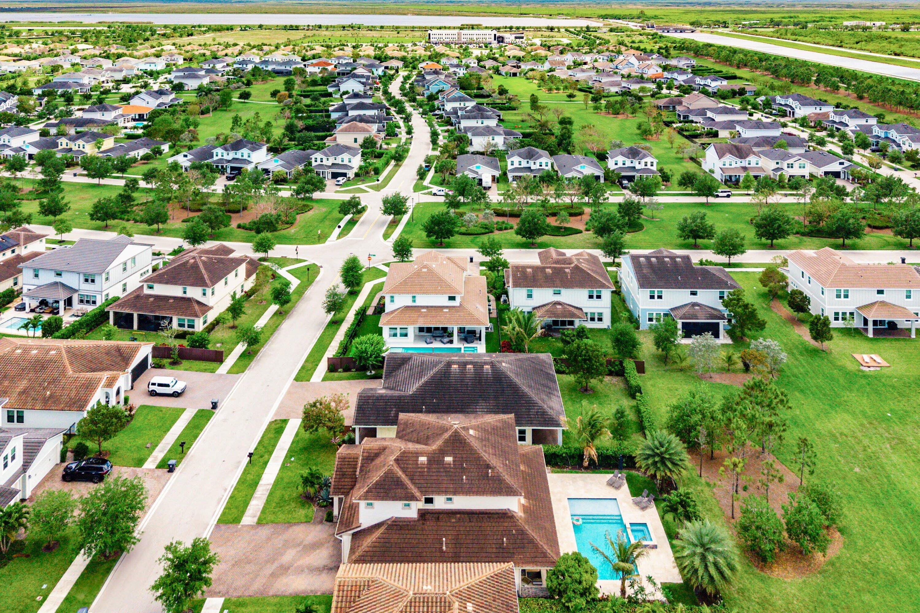 1031 Ember Ridge Run Loxahatchee, FL 33470 - Photo 50 of 52 an aerial view of residential houses with outdoor space