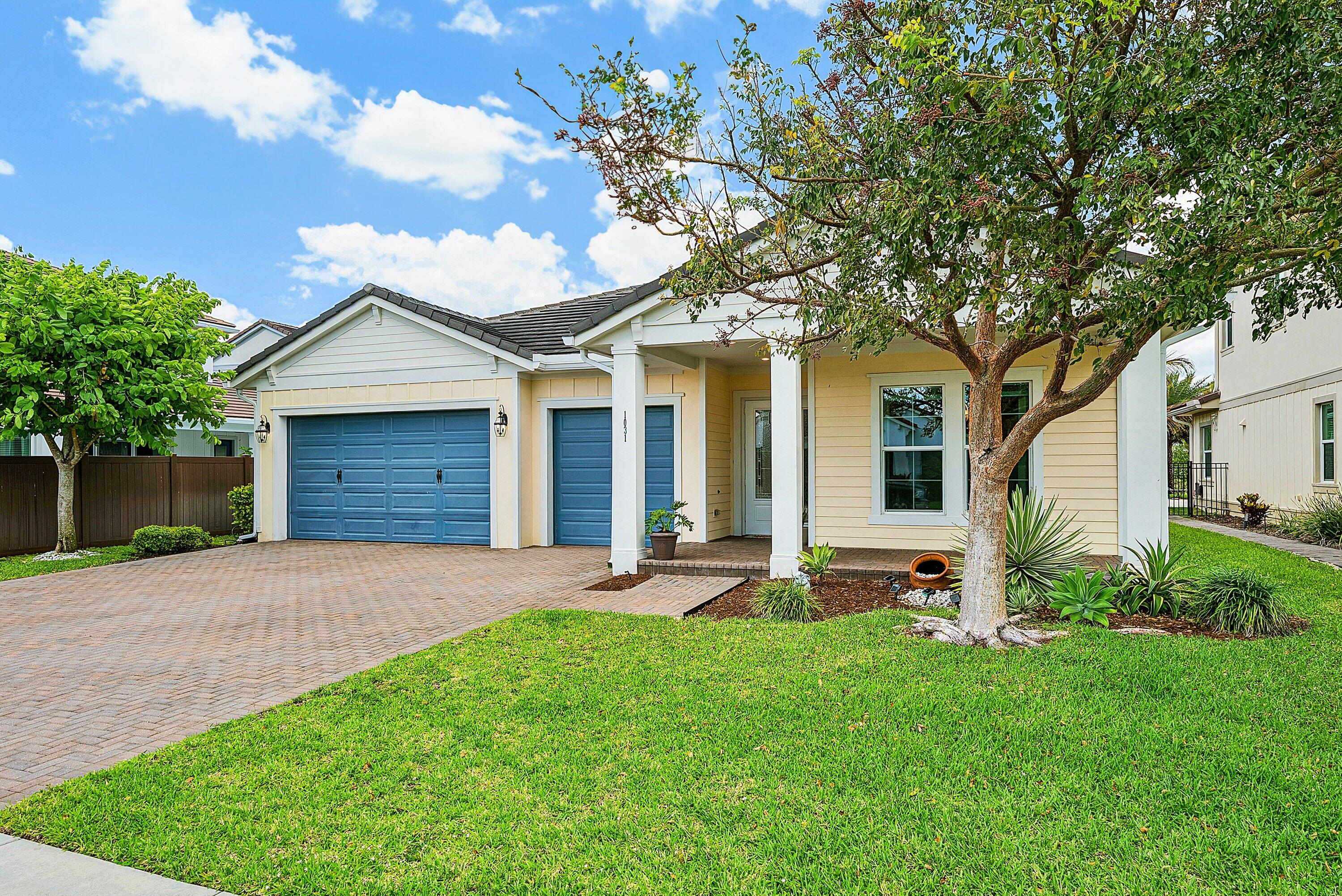 1031 Ember Ridge Run Loxahatchee, FL 33470 - Photo 52 of 52 a front view of a house with a garden and yard