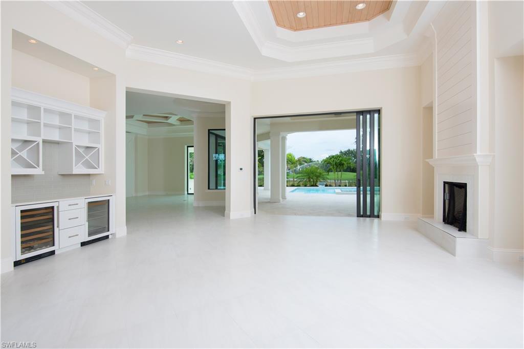 28891 Somers Drive Naples, FL 34119 - Photo 3 of 15 an empty room with furniture and a window