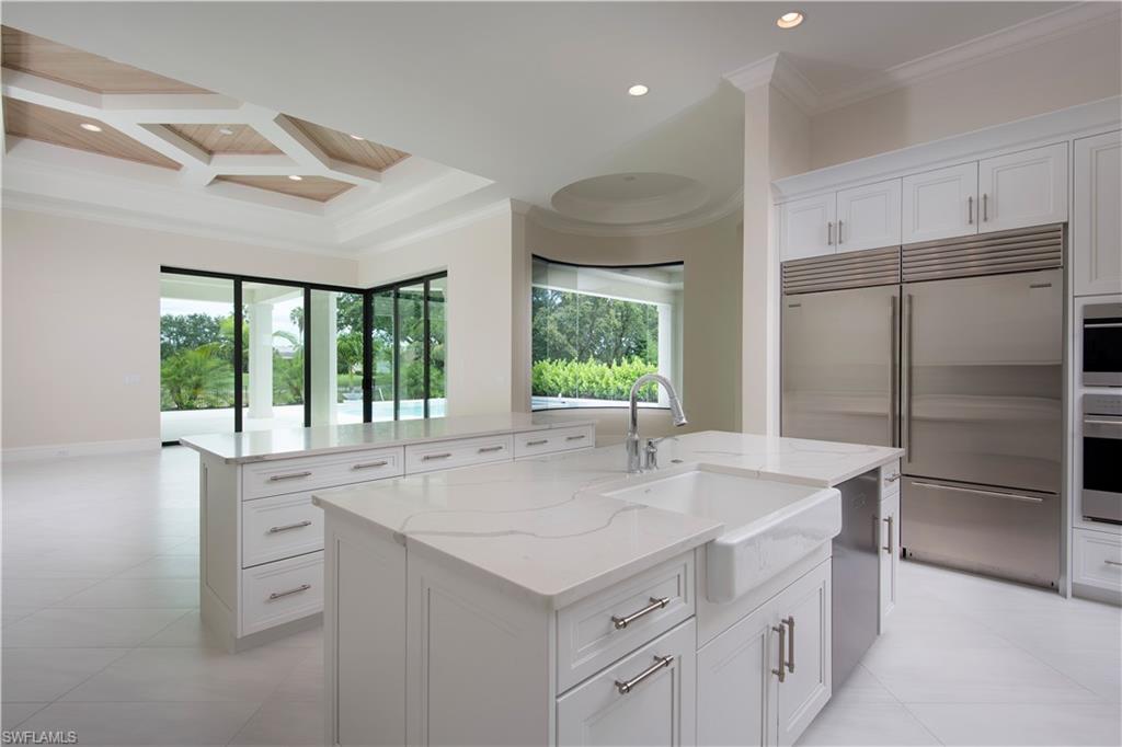 28891 Somers Drive Naples, FL 34119 - Photo 5 of 15 a kitchen with kitchen island a sink stove and refrigerator