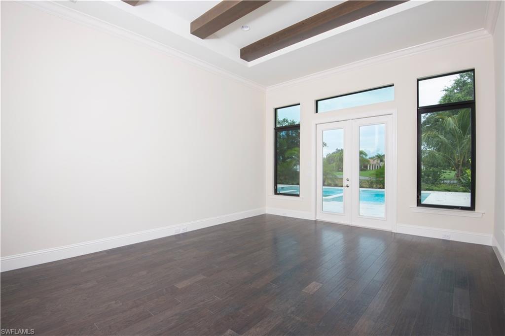 28891 Somers Drive Naples, FL 34119 - Photo 10 of 15 an empty room with wooden floor and windows