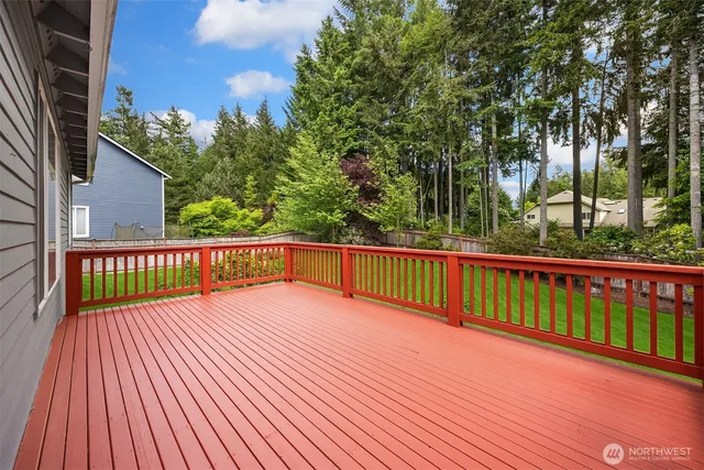 a view of deck with a wooden floor and fence