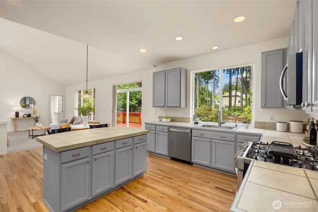 a kitchen with a sink stove and cabinets