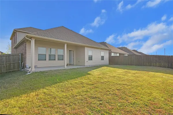 a view of a house with a backyard