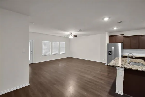 a view of kitchen with wooden floor electronic appliances and window