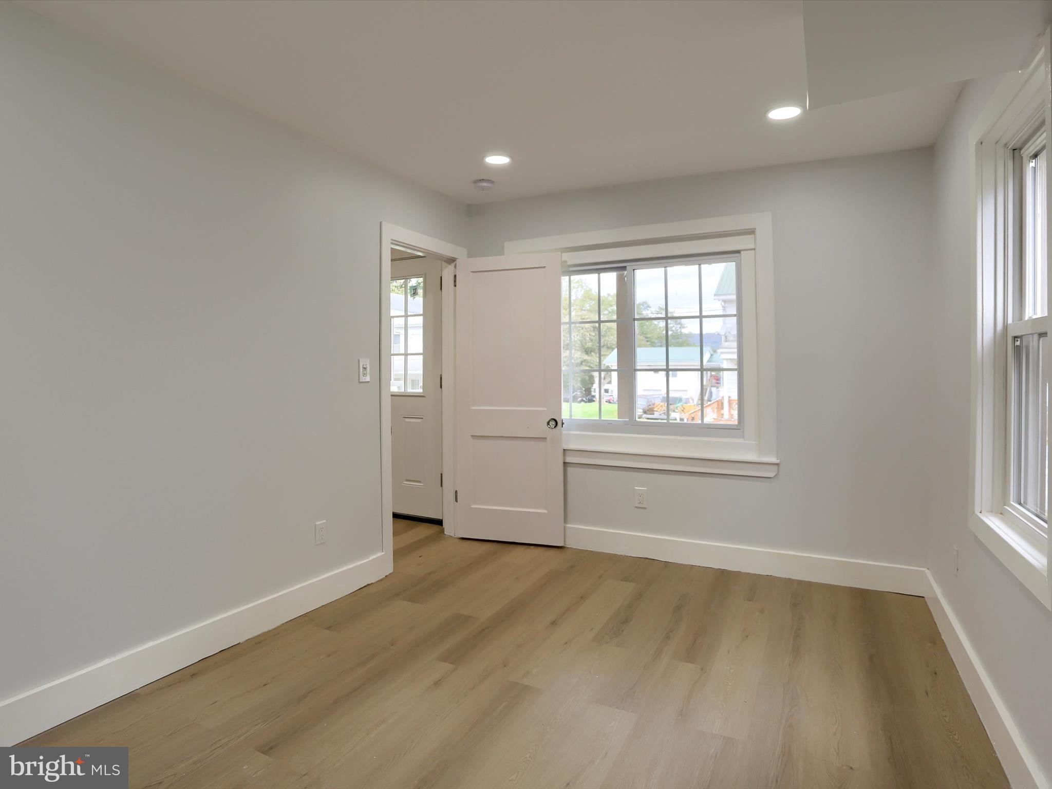9963 Jonestown Road Grantville, PA 17028 - Photo 17 of 41 an empty room with wooden floor and windows