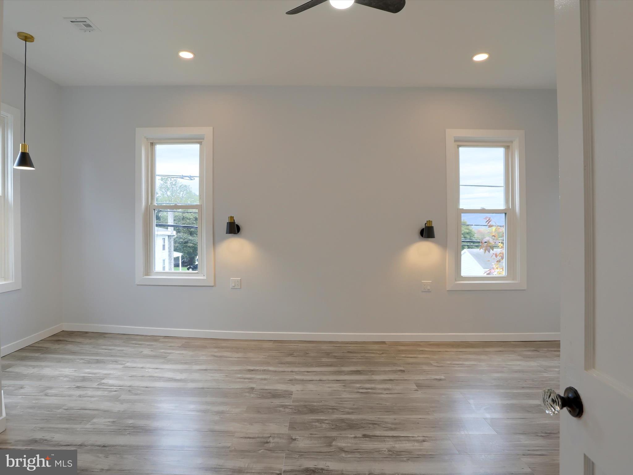 9963 Jonestown Road Grantville, PA 17028 - Photo 22 of 41 an empty room with wooden floor and windows