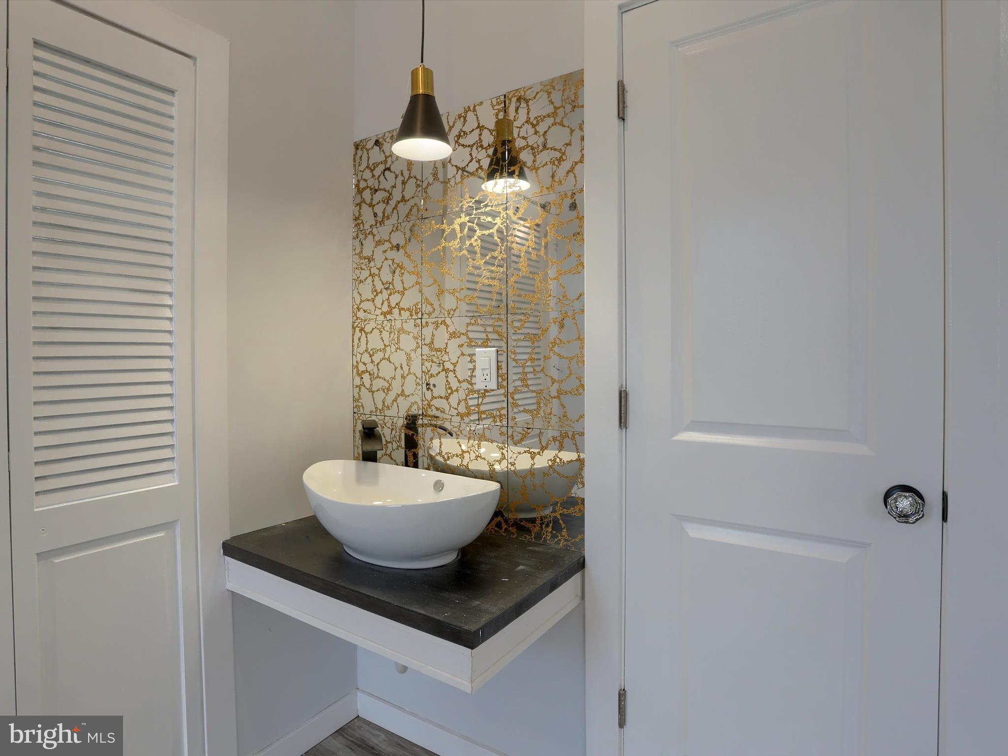 9963 Jonestown Road Grantville, PA 17028 - Photo 25 of 41 a bathroom with a granite countertop sink a toilet a mirror and shower