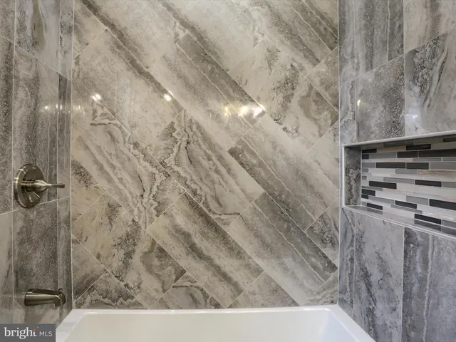 a bathroom with a sink vanity and mirror