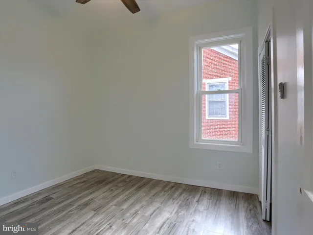 an empty room with wooden floor and closet