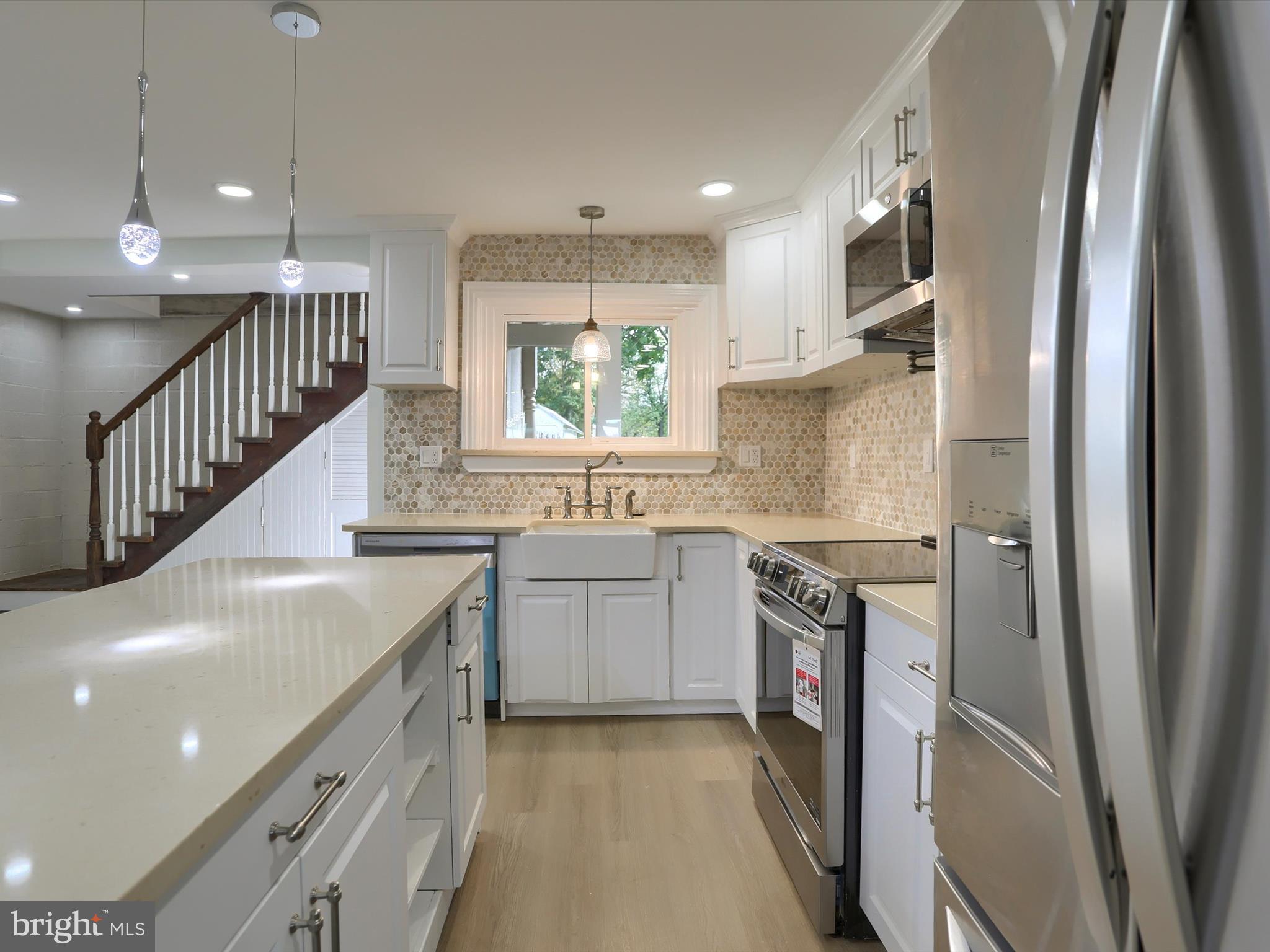 9963 Jonestown Road Grantville, PA 17028 - Photo 7 of 41 a kitchen with granite countertop a sink stove and refrigerator