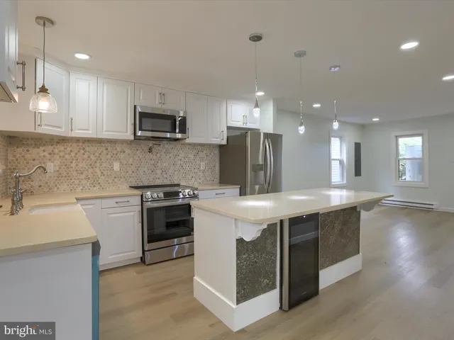 a kitchen with a sink stove and refrigerator