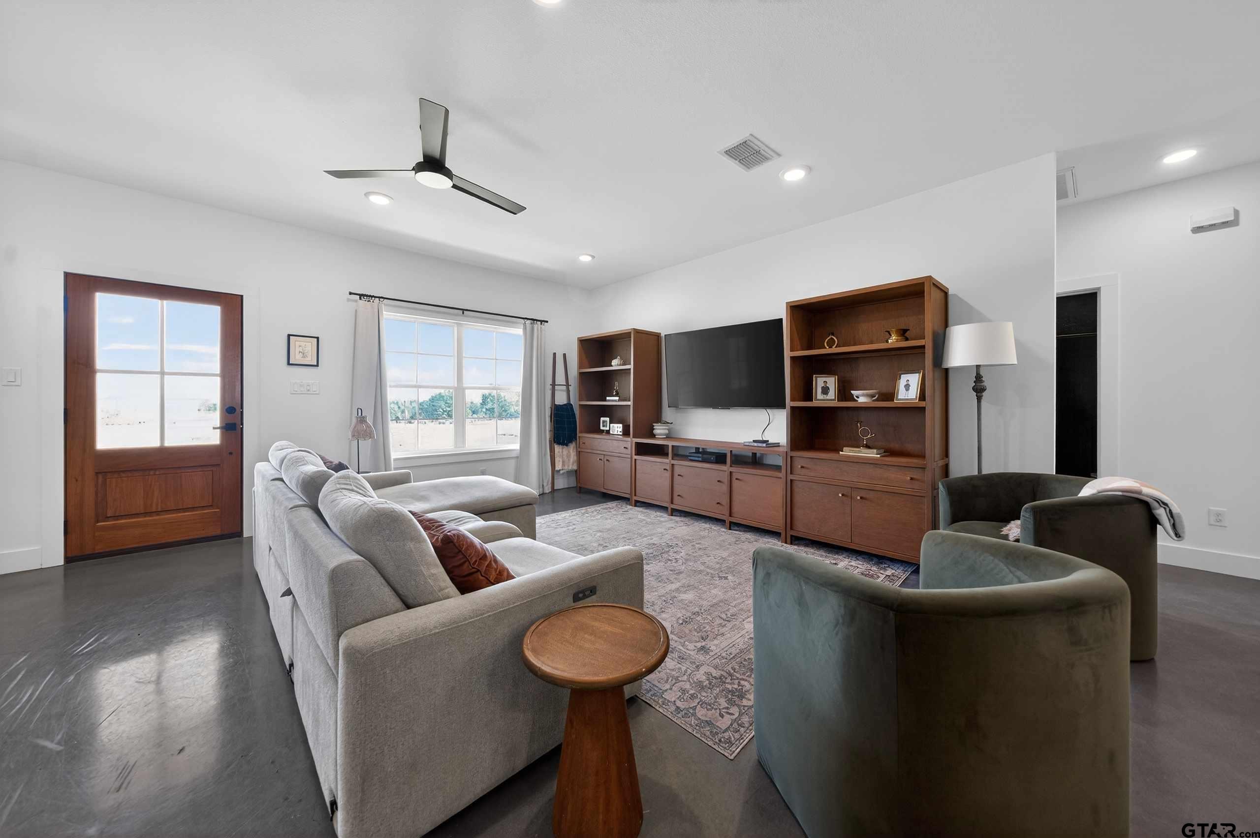 305 Gallatin Cut-Off Road Jacksonville, TX 75766 - Photo 16 of 46 a living room with furniture and a flat screen tv