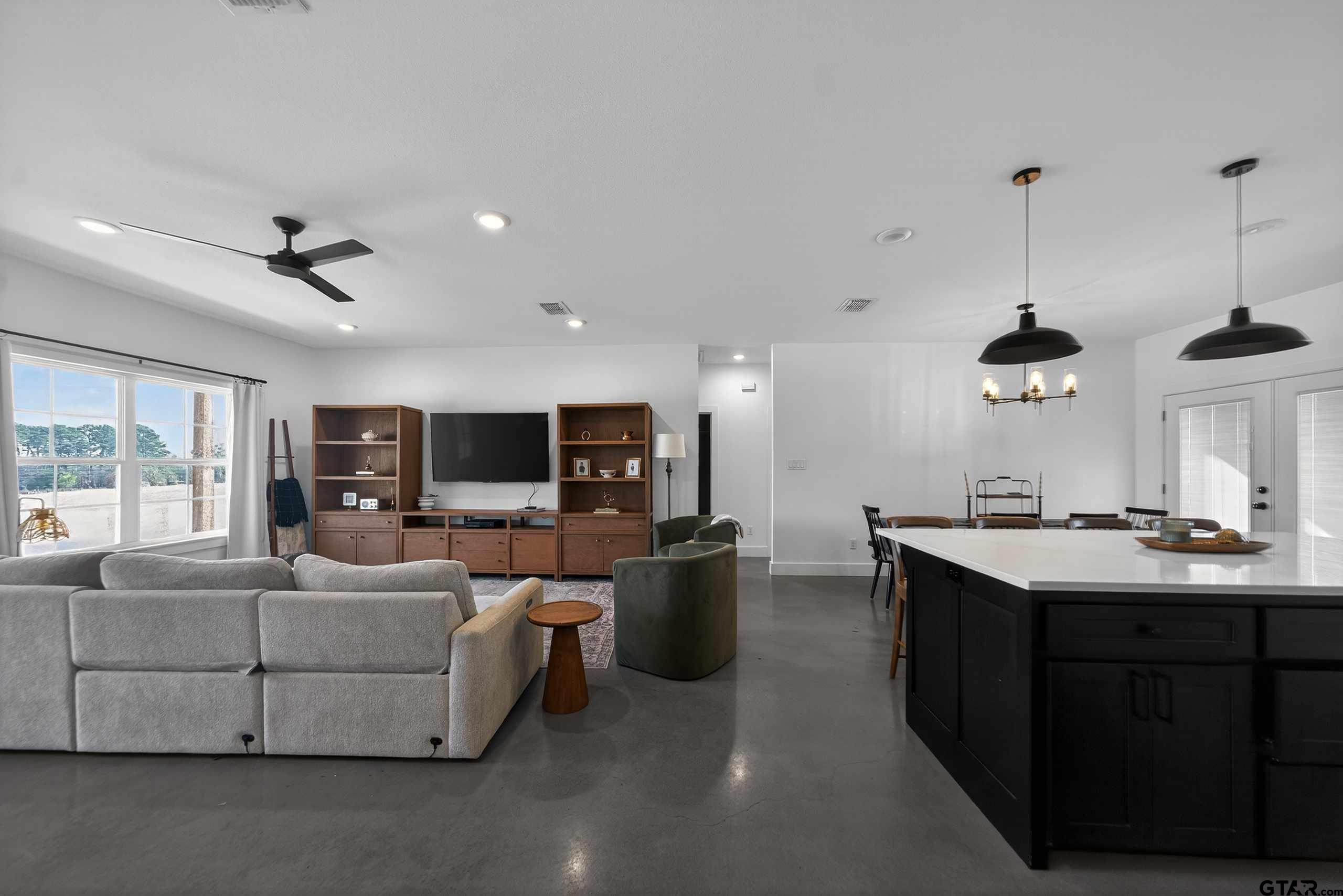 305 Gallatin Cut-Off Road Jacksonville, TX 75766 - Photo 18 of 46 a living room with furniture kitchen view and a flat screen tv