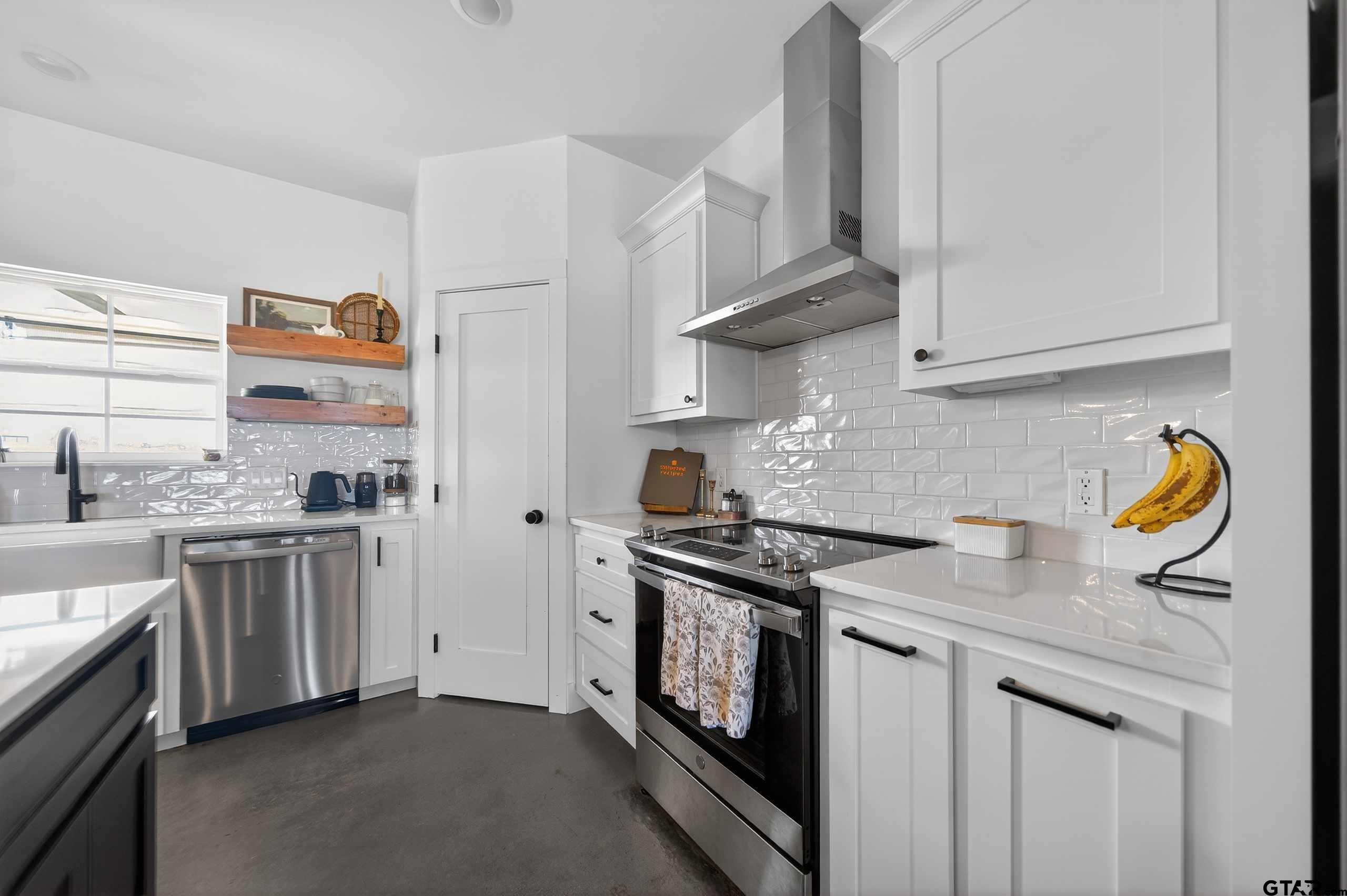 305 Gallatin Cut-Off Road Jacksonville, TX 75766 - Photo 21 of 46 a kitchen with stainless steel appliances granite countertop a stove and a sink