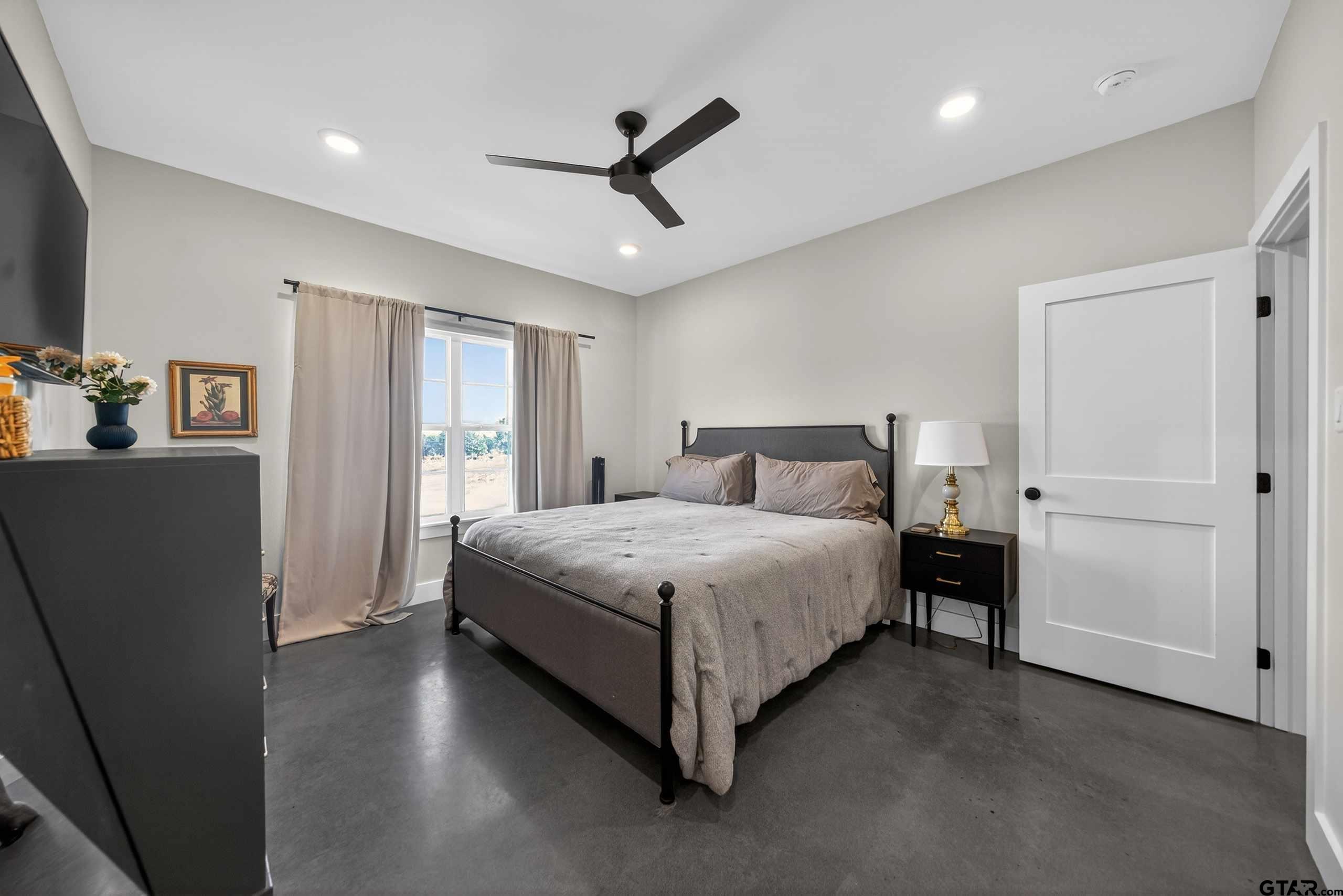 305 Gallatin Cut-Off Road Jacksonville, TX 75766 - Photo 31 of 46 a bedroom with a bed and a large window