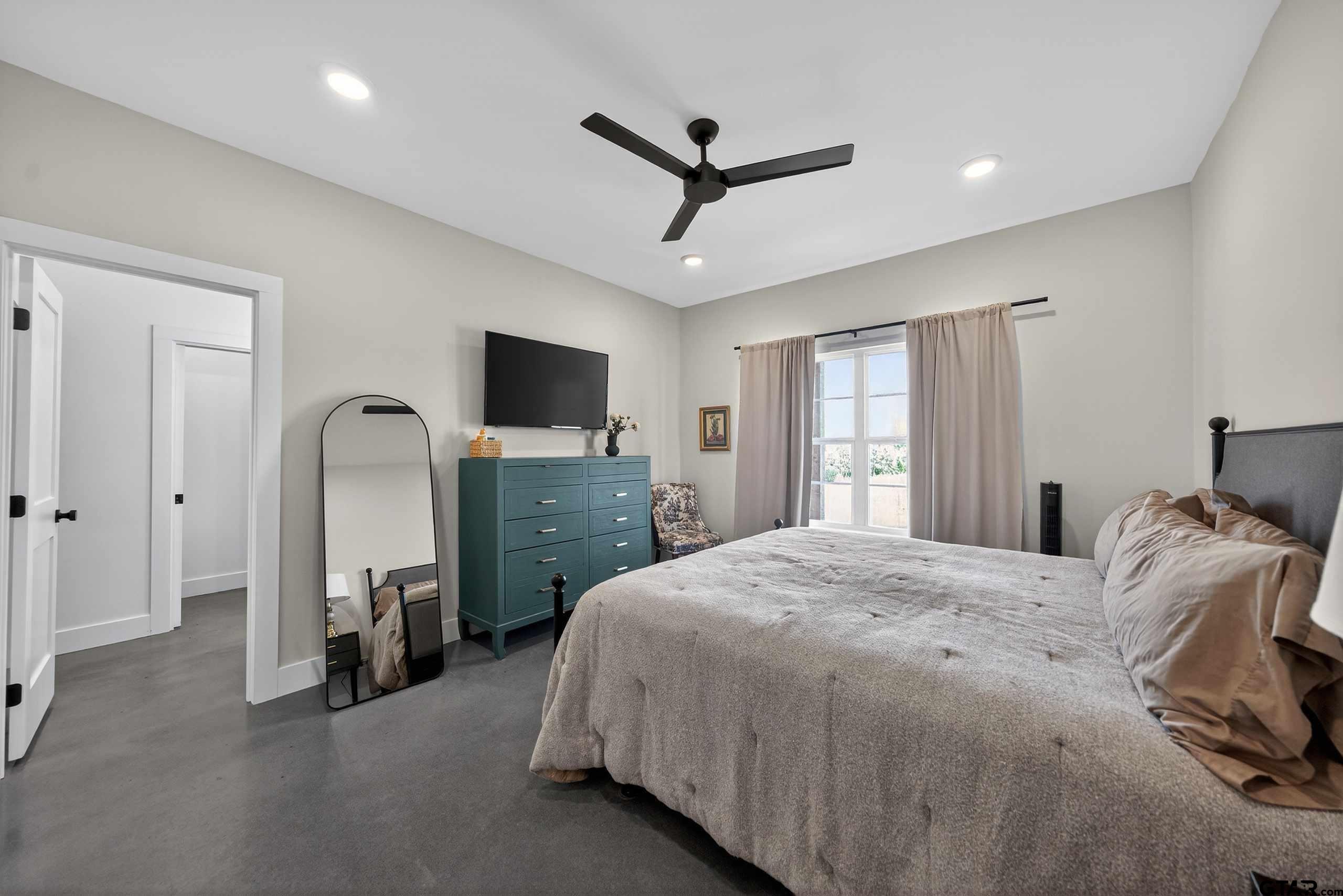 305 Gallatin Cut-Off Road Jacksonville, TX 75766 - Photo 32 of 46 a bedroom with a bed a window and a flat screen television