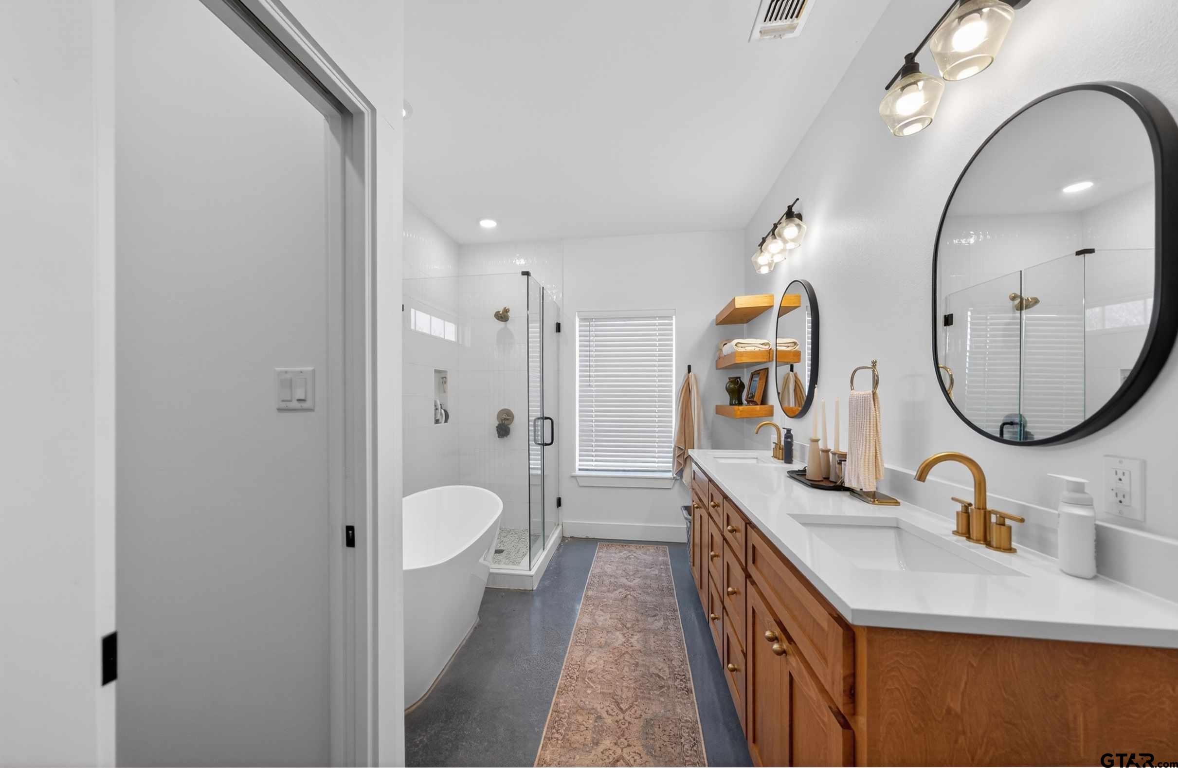 305 Gallatin Cut-Off Road Jacksonville, TX 75766 - Photo 34 of 46 a bathroom with a granite countertop double vanity sink and a mirror