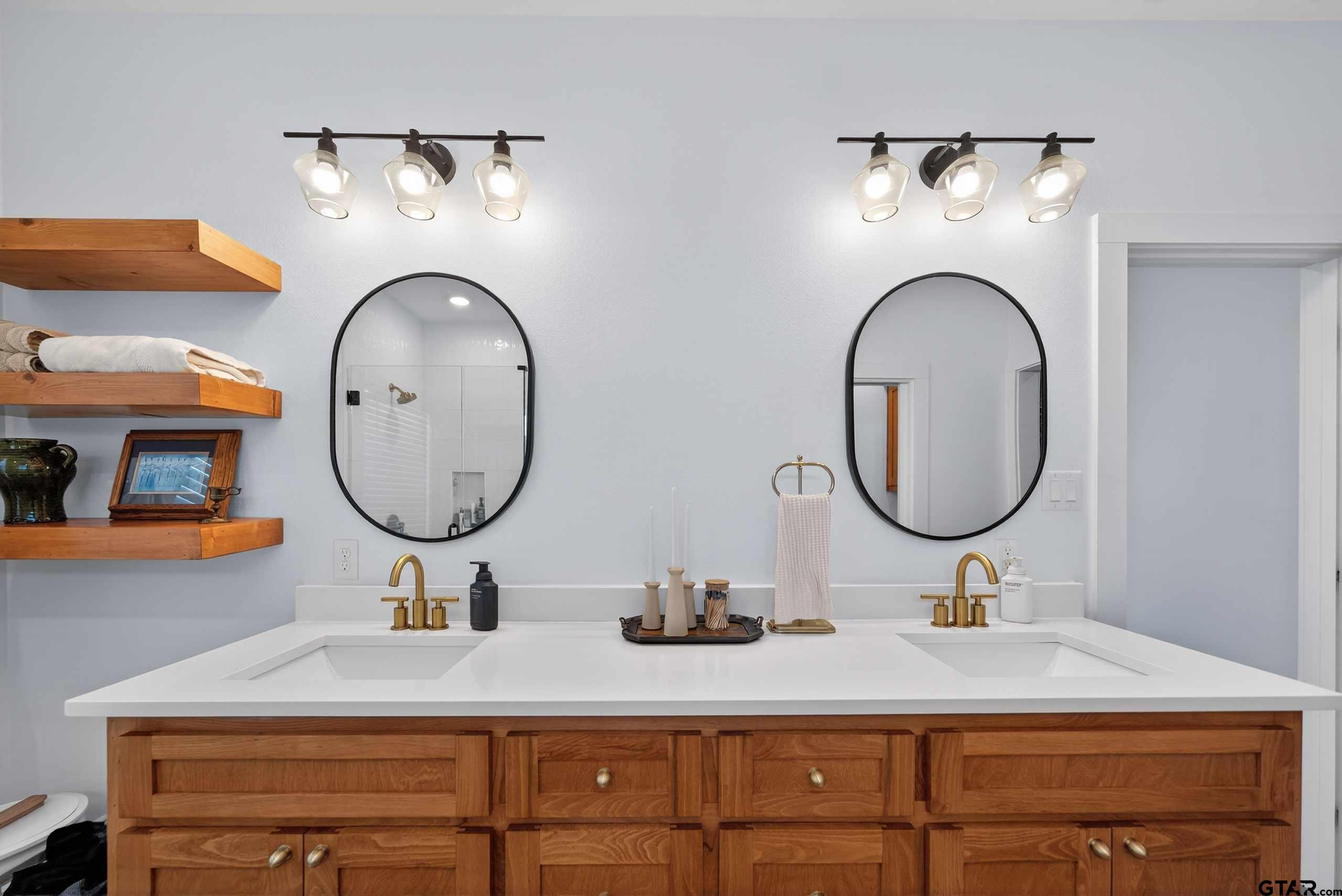 305 Gallatin Cut-Off Road Jacksonville, TX 75766 - Photo 36 of 46 a bathroom with a sink and a mirror