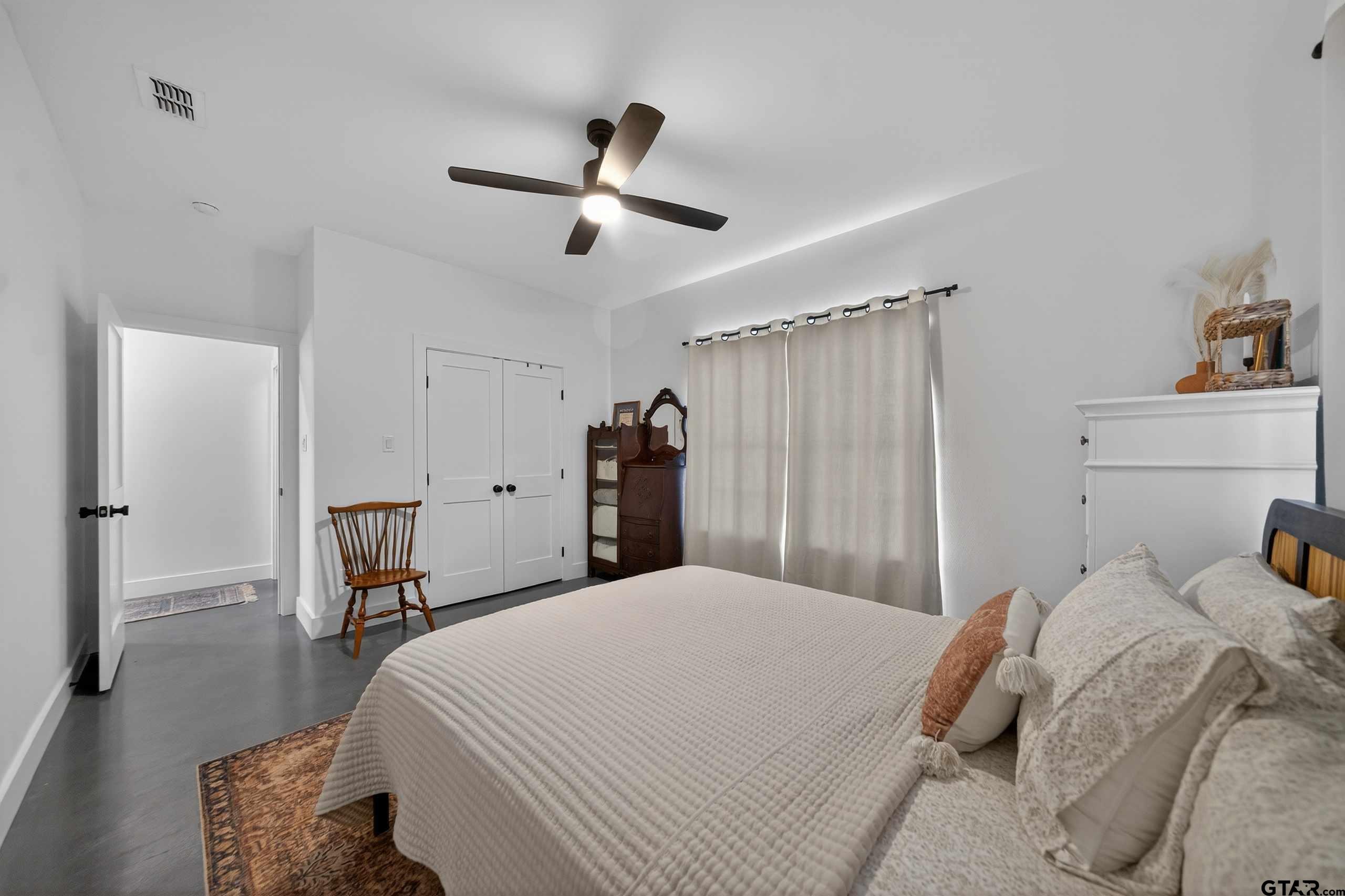 305 Gallatin Cut-Off Road Jacksonville, TX 75766 - Photo 40 of 46 a bedroom with a bed and a chandelier