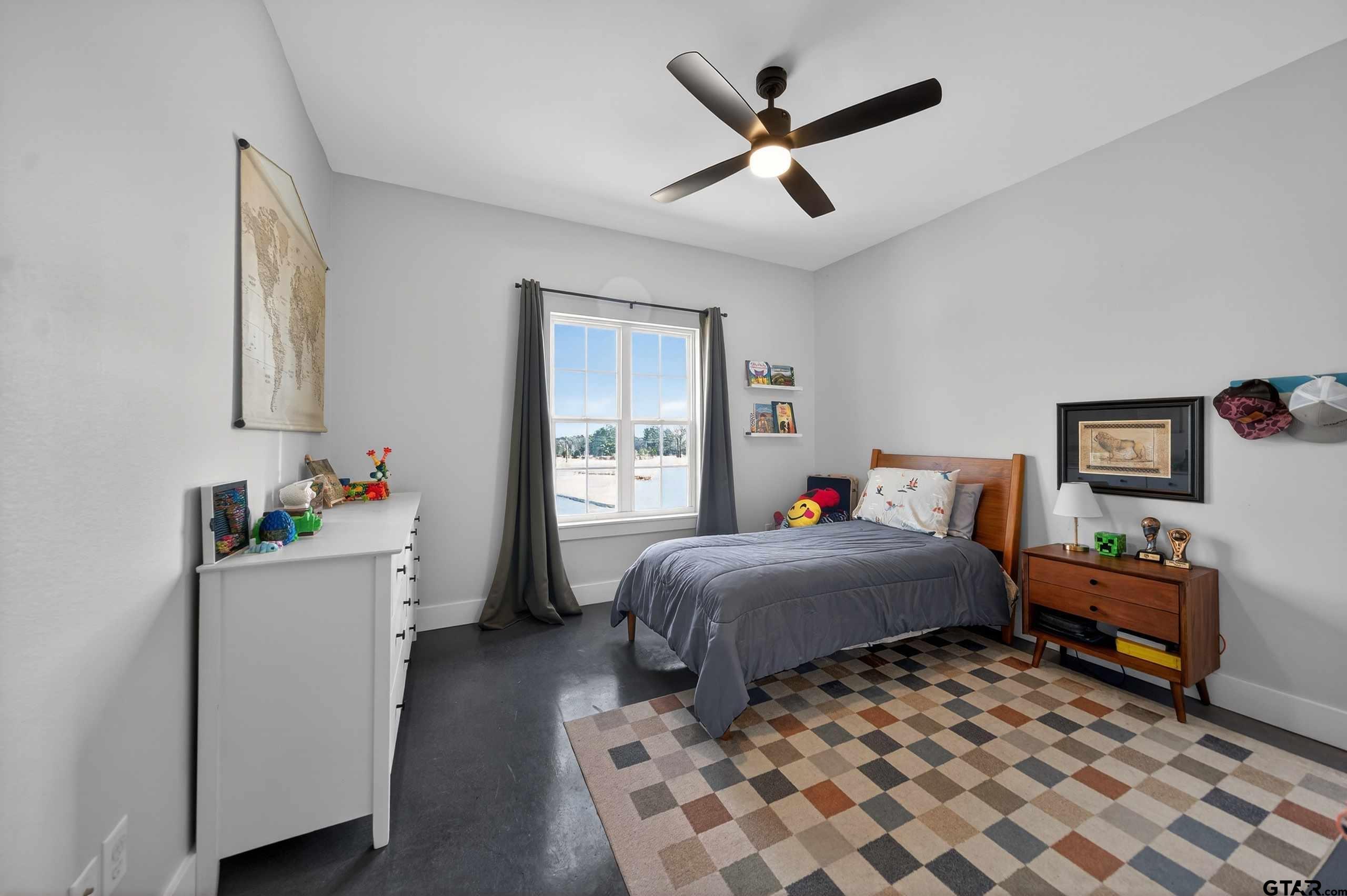 305 Gallatin Cut-Off Road Jacksonville, TX 75766 - Photo 41 of 46 a bedroom with a bed and a chandelier