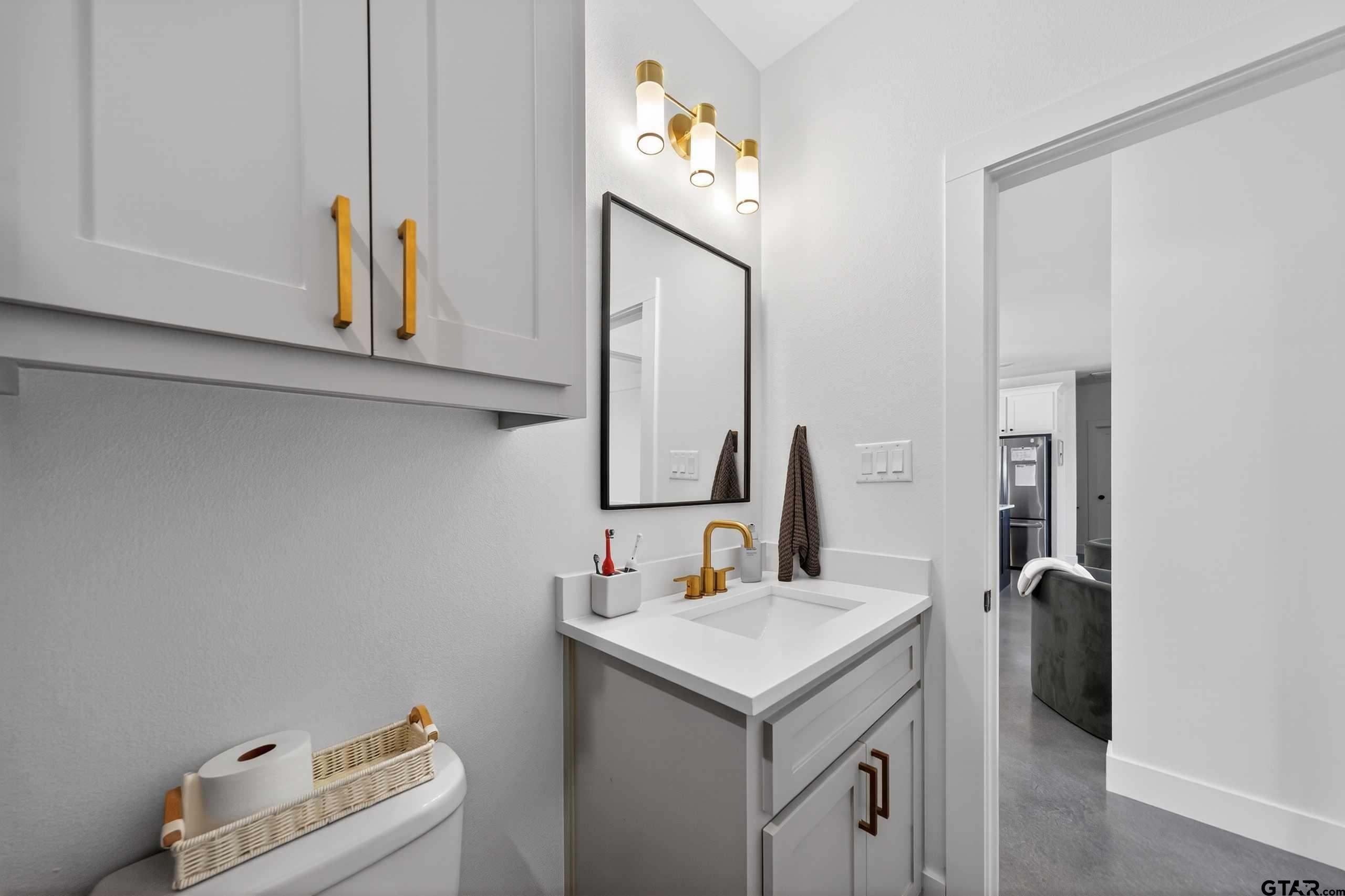 305 Gallatin Cut-Off Road Jacksonville, TX 75766 - Photo 44 of 46 a bathroom with a sink and a mirror