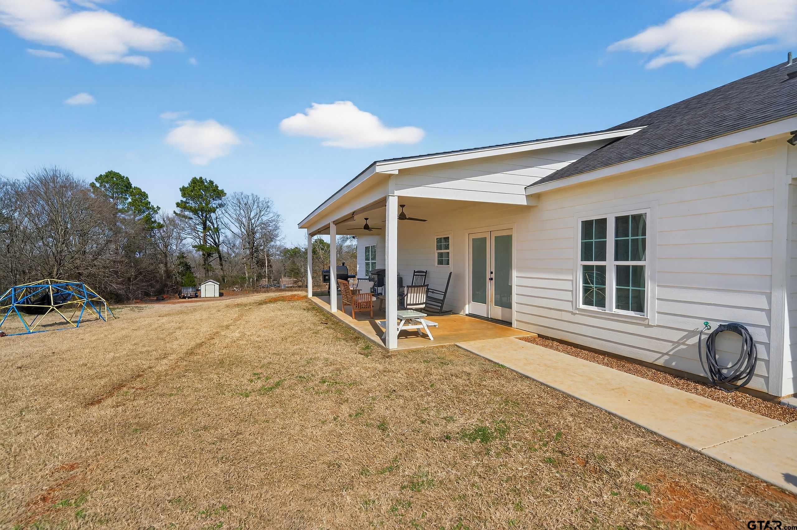 305 Gallatin Cut-Off Road Jacksonville, TX 75766 - Photo 8 of 46 a view of a house with backyard and sitting area