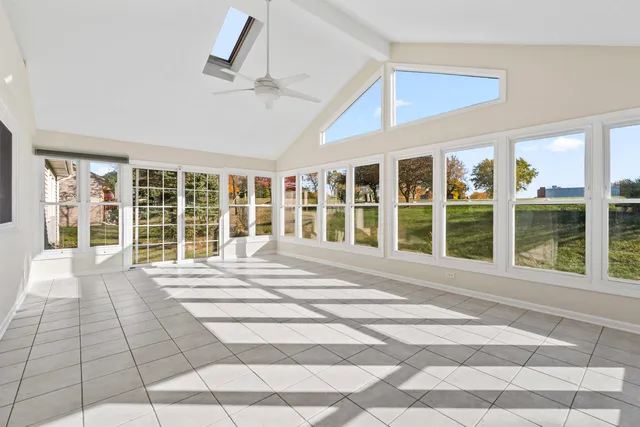 a view of an empty room with a fireplace and windows