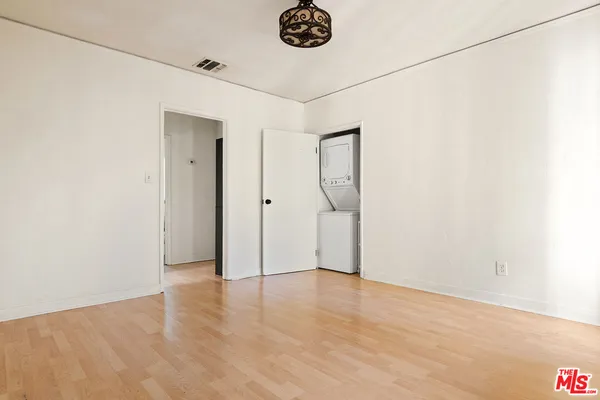 a view of a room with wooden floor and white walls