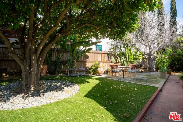 a view of a backyard with a garden and trees