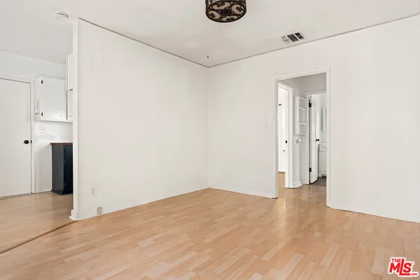 a view of a room with wooden floor