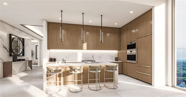 a kitchen with stainless steel appliances kitchen island granite countertop a table chairs and a refrigerator