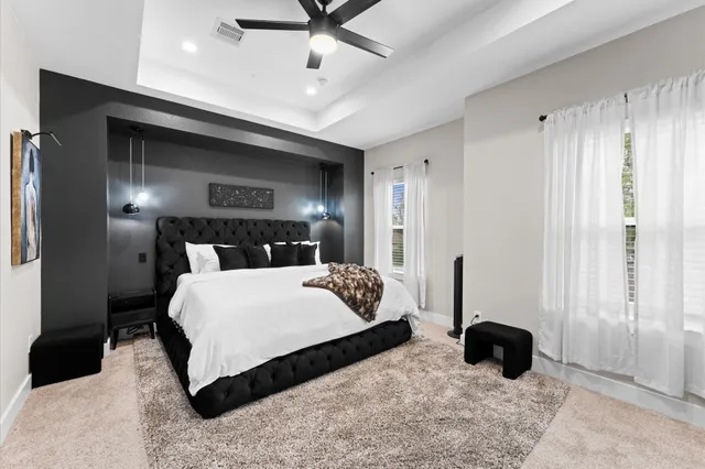 a bedroom with a bed and ceiling fan