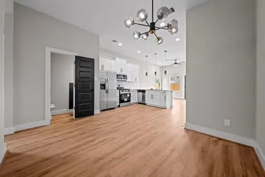 a view of a kitchen with a sink and dishwasher a refrigerator freezer