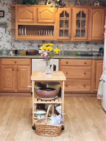 a kitchen with a stove a sink and a cabinets