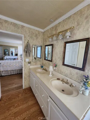 a bathroom with a double vanity sink and a mirror