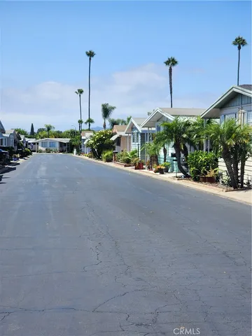 a front view of a building with a garden and plants