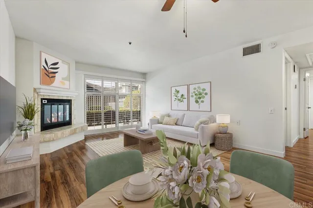 a living room with furniture large window and a fireplace