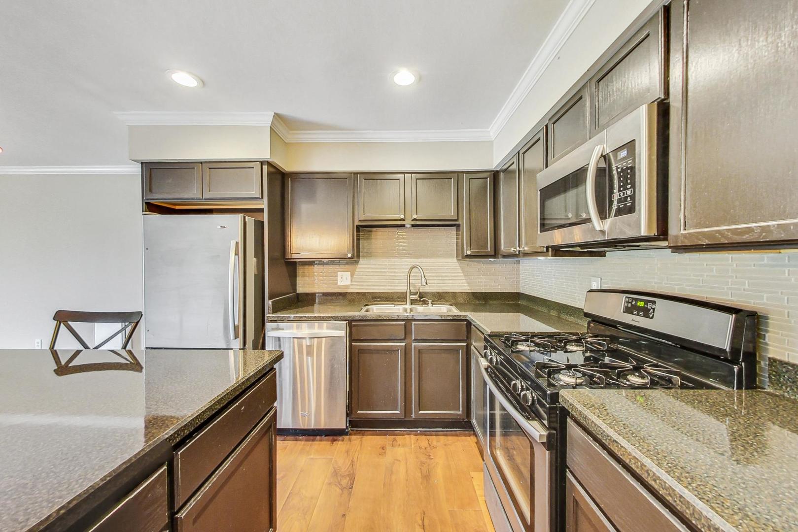 19398 Wolf Road, Unit 11 Mokena, IL 60448 - Photo 11 of 27 a kitchen with a stove and a refrigerator