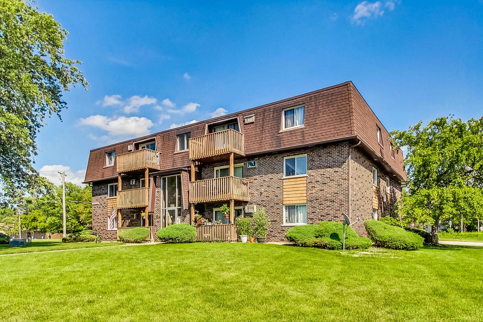 19398 Wolf Road, Unit 11 Mokena, IL 60448 - Photo 2 of 27 a view of a house with a big yard and large trees