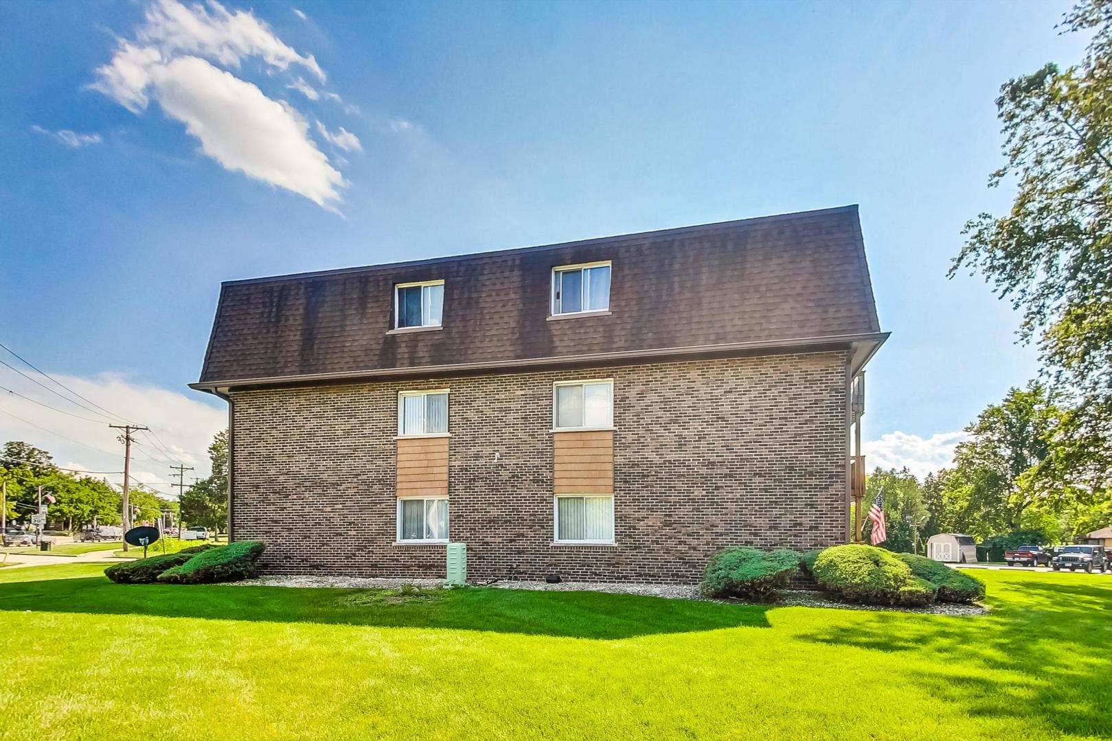 19398 Wolf Road, Unit 11 Mokena, IL 60448 - Photo 3 of 27 a brick house with a yard in front of it
