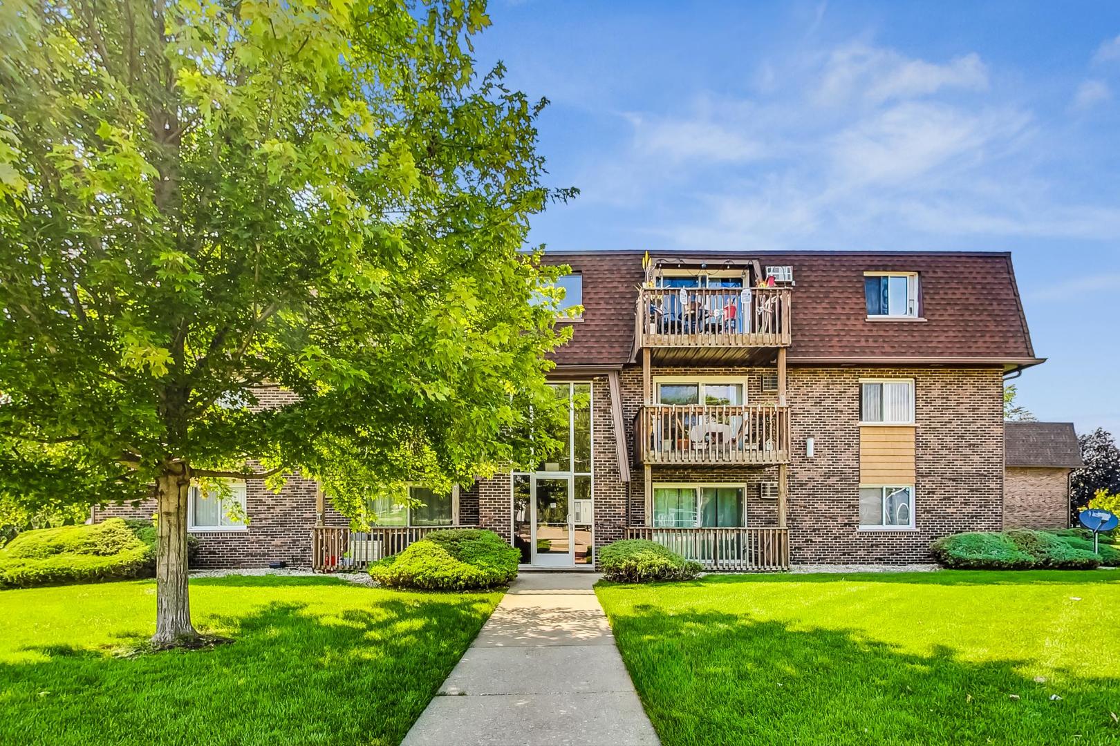 19398 Wolf Road, Unit 11 Mokena, IL 60448 - Photo 4 of 27 a front view of a house with a yard