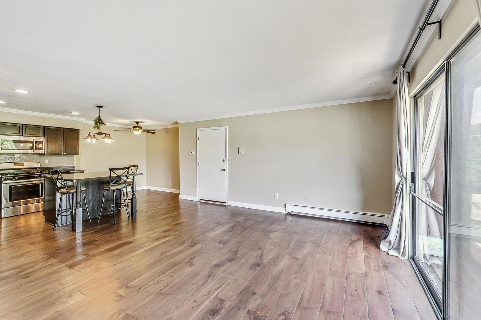 19398 Wolf Road, Unit 11 Mokena, IL 60448 - Photo 9 of 27 an empty room with wooden floor and windows
