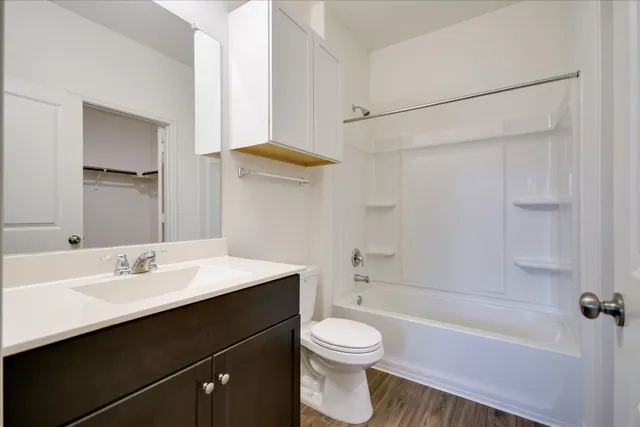 a bedroom with a bed and a flat tv screen on the dresser